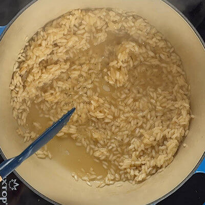 Step 2 - Make the risotto. For all the details, go to my Basic Risotto recipe. Heat oil in a Dutch oven and sweat the onion. Add the rice, and stir until the rice grains are coated with the butter. Allow to cook for a little. Add the white wine and allow it to be absorbed by the rice. Once absorbed, add the broth, ladle by ladle until all liquids are absorbed by the rice.