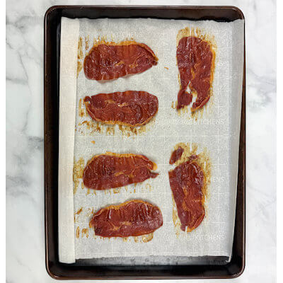 Step 7 - In order to add some extra crunch, protein and flavor to your risotto dish, make crispy Prosciutto. Line a baking sheet with parchment paper and lay the prosciutto slices flat without overlapping each other. Place the baking sheet in an oven of 375°F for about 10 minutes. Allow them to cool just a little and serve with the risotto.