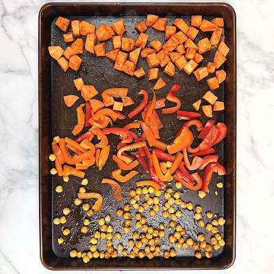 Step 2 - Wash and peel the sweet potato and cut in cubes, wash red bell pepper and cut in strips. Rinse chickpeas, dry and remove loose skin. Place all three on the baking dish. Sprinkle with olive oil and then with a mix of smoked paprika, cumin, garlic powder, salt and pepper.