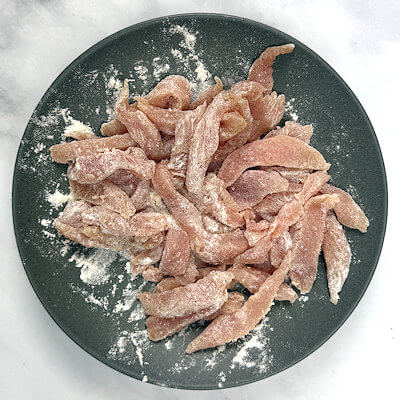 Step 2 - Cut turkey tenderloin in thin strips, season them with salt and pepper and then dust with all-purpose flour.