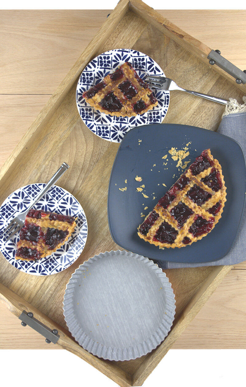 Cherry pie cut in wedges on a serving tray