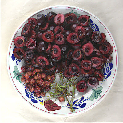 Step 1 - Pit the cherries. You can buy a cherry pitter, but I can tell you that a little kitchen knife will do just fine. Cut the cherries in half and the halves in half again. The smaller pieces will be easier when filling up a small cherry pie crust. Cherry halves may leave empty spaces/wholes in your pie and you may end up with having difficulties getting the cherries in your pie crust.