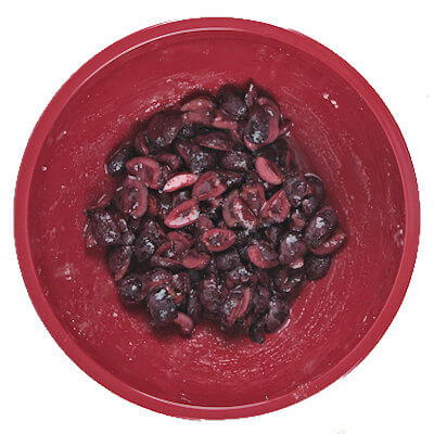 Step 2 - Mix the cut cherries with sugar (for some sweetness), corn starch (for thickening and binding), lemon juice (for tartness), and vanilla and almond extract (for additional flavor).