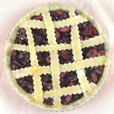 Step 3 - Roll out the pie crust and line the baking dish. Reserve the left-over for the lattice.Transfer the cherry mixture into the pie dish and cover with a lattice. Lightly brush lattice with egg wash and sprinkle with turbinado sugar. The egg wash give the lovely golden color and the coarse sugar will give this delicious crunch.