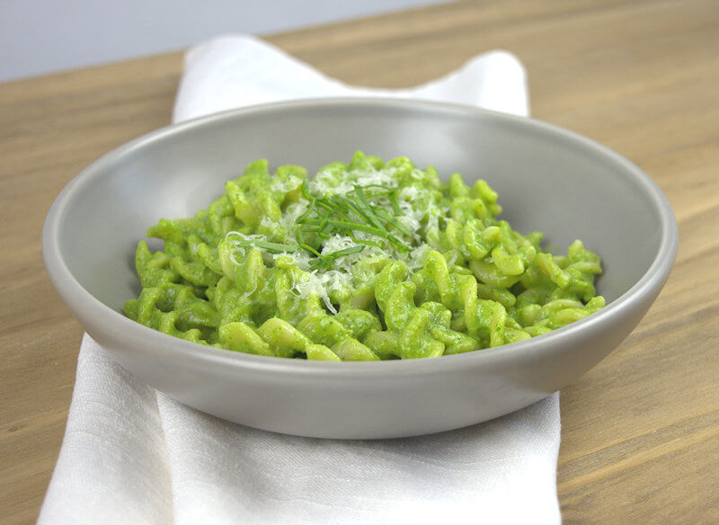 Side view of no guilt Avocado Spinach Pasta in grey dish.