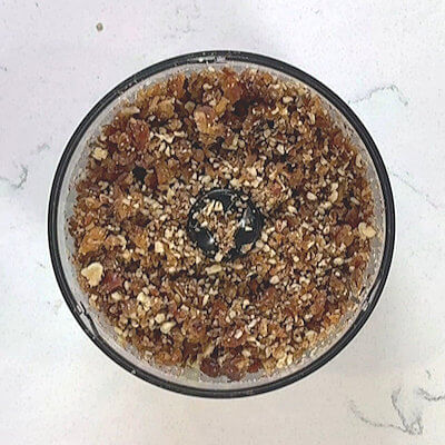 Step 1 - Make the pecan-date crust by pulsing both in a food processor until it reaches a coarse consistency that will form a ball. If it does not stick together, pulse a few more times.