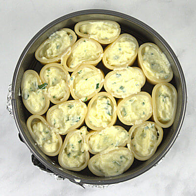 Step 5 - Transfer the ricotta mixture into a Ziploc bag, cut a small corner off and pipe it in the pasta. Fill each tube half way.