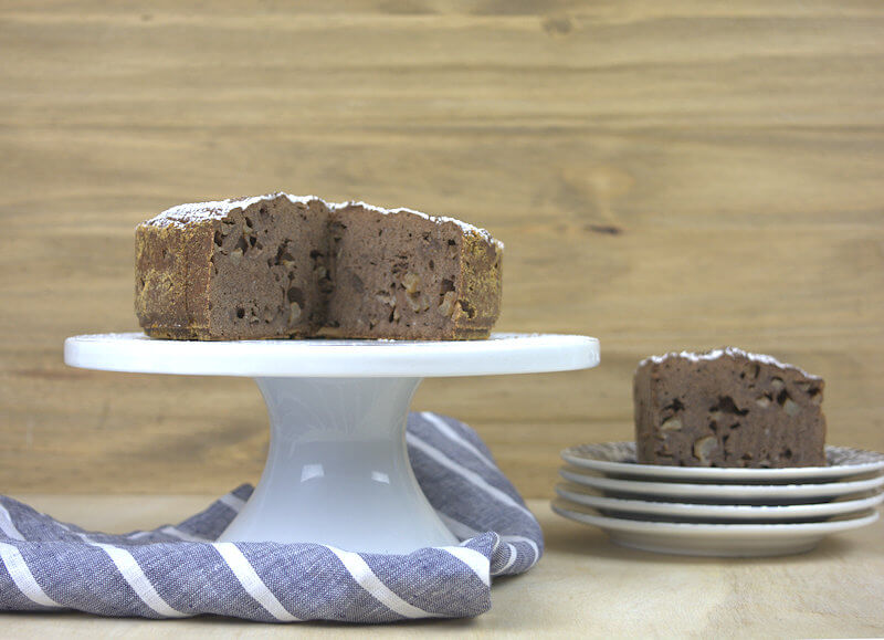 The chocolate pear cake with one wedge cut out.