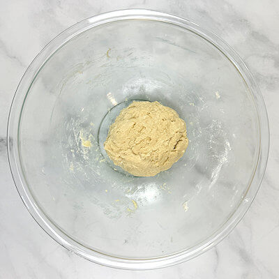 Step 2 - Mix flour, salt, milk, melted butter, beaten egg and yeast mixture, creating a dough. It is a sticky dough.