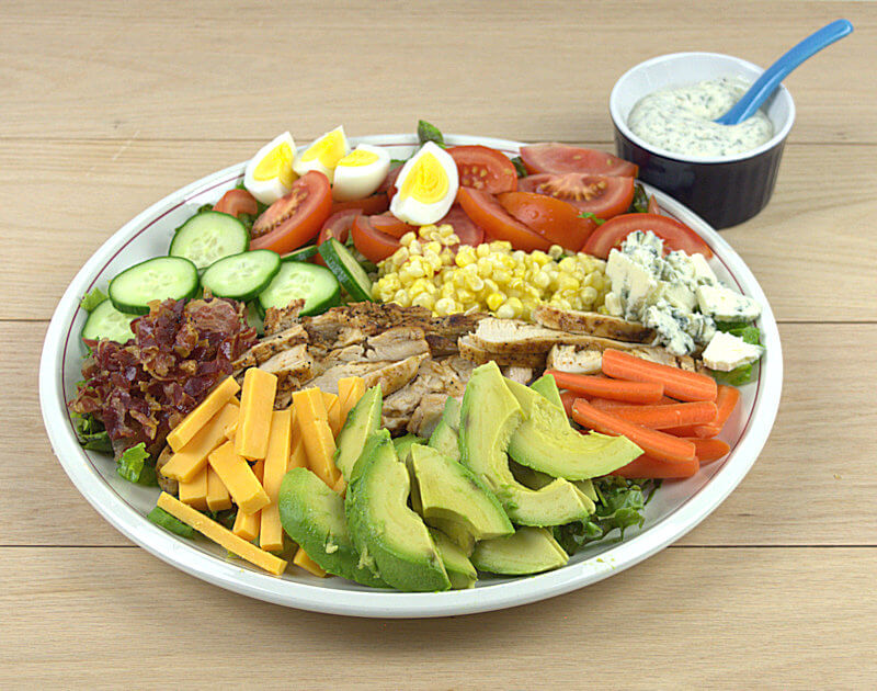 Cobb salad with a small bowl of ranch dressing
