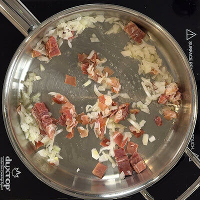 Step 1 - Heat butter in a high walled skillet or Dutch oven and saute the onion and Prosciutto until crispy. Stir regularly, you don't want it to burn. Remove from pan and allow to drain on a paper towel.