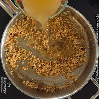 Step 4 - Add the chicken broth (or vegetable broth if you prefer) ladle by ladle and allow the rice to absorb the liquid before you add the next ladle. Make sure the stock is not cold; warm it before you add it to the risotto.
