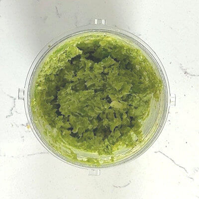 Step 4 - Transfer the well-drained vegetables, shredded cheese, and lemon zest into a blender and mix until fine. It does not have to be as fine as pesto, a little bite here and there is fine. Add salt, pepper and the nutmeg to taste and mix again.