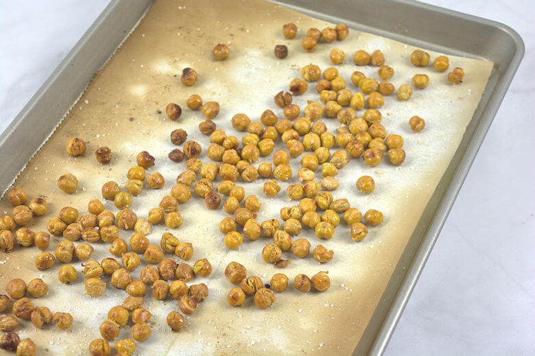 Transfer the chickpeas to a baking sheet, drizzle with olive oil and sprinkle generously with coarse salt. Slide into the oven (400 degrees F.) and roast for 30-40 minutes.