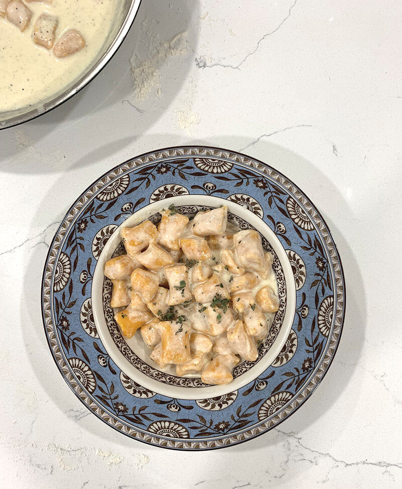 Plate with Sweet Potato Ricotta Gnocchi in Cheese Sauce