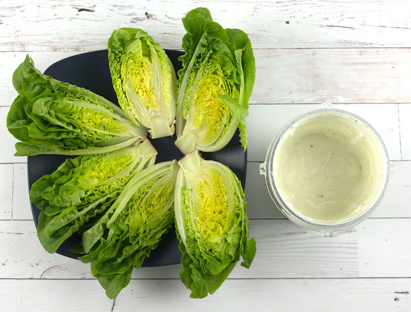 Cut gem lettuce and dressing
