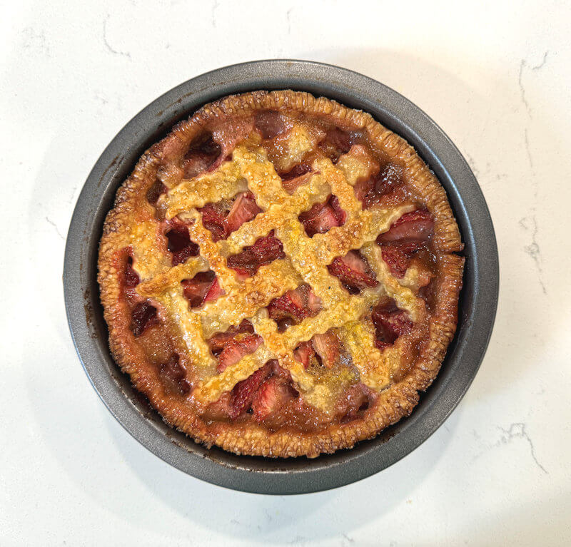 Baked strawberry lattice pie, still in pie dish.