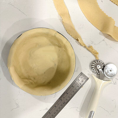 Step 1 - Thaw the pie crust according to the description on the packaging. Roll the pie crust approx. 1-2 inch wider than your pie dish and transfer to that dish. Cut the remaining dough for your lattice, using a knife or a straight or fluted pastry cutter. Place strips on parchment paper. Place pie dish and lattice strips in the fridge for later use.