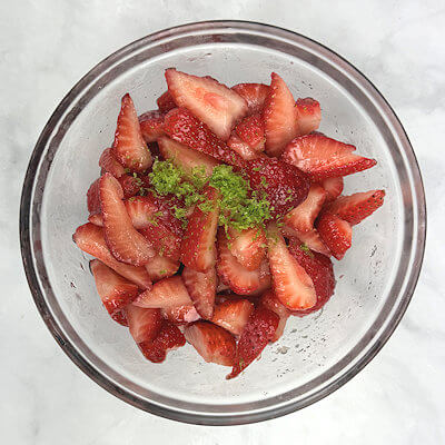 Step 3 - Drain liquid from strawberries and add lime zest, lemon juice, black pepper, sugar, brown sugar and cornstarch and mix.