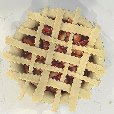 Step 4 - Transfer strawberry mix into pie dish and cover with the lattice strips you made earlier.