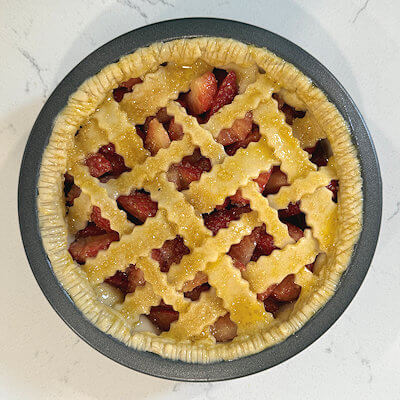 Step 5 - Crimp the edges of the pie for a nice presentation. Brush egg wash over pie dough and sprinkle with turbinado sugar.