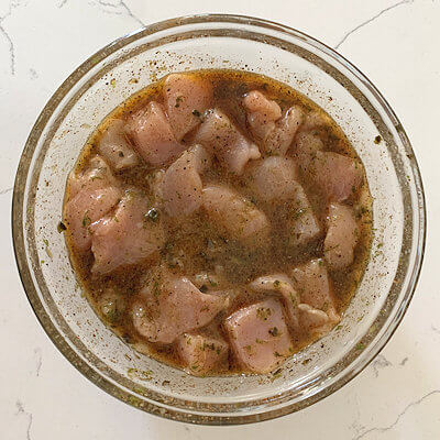 Step 1 - Marinade the chicken. Transfer all ingredients for the marinade into the bowl and mix. Cut the chicken in pieces of equally-sized cubes and place them in the marinade.
