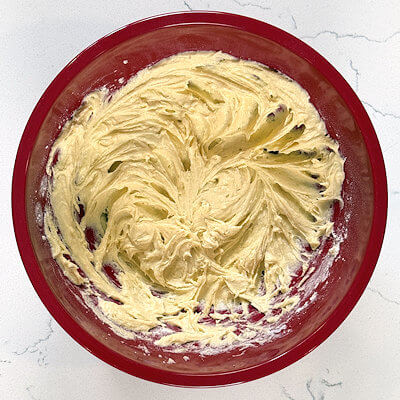 Step 4 - Mix the flour with baking powder and salt and add this gradually to the mixture until just combined. 