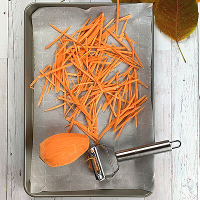 Step 2 - Cut the sweet potato, carrots, bell pepper and celery into julienne. You can do this the traditional way, hand-cut with a knife, or cut them with a special vegetable peeler.Spread the sweet potato pieces onto a baking sheet, covered with parchment paper. Drizzle with olive oil and sprinkle with salt & pepper. Bake in a 400°F oven for about 15 minutes. Allow them to cool.Transfer all vegetables into a large bowl.