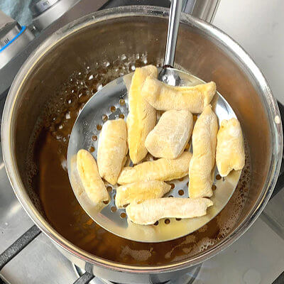 Step 6 - Heat up the water in which you cooked the beets. Use a slotted spoon and add the gnocchi in batches. Cook until the gnocchi float to the surface and transfer the gnocchi to a baking sheet lined with parchment paper.