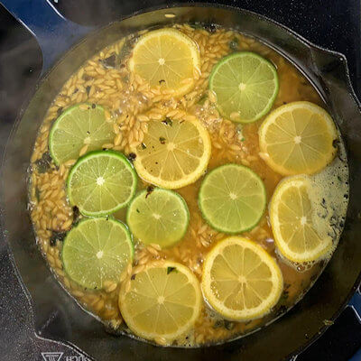 Step 3 - Add chicken stock to the orzo and when mixed, add the lemon and lime slices. Add the chicken breast back into the skillet and allow to cook until done or reached internal temperature of 165 degrees F.