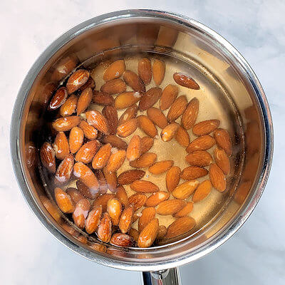 Step 1 - Bring water to boil in a small pan. Add the almonds and cook for 1 minute.