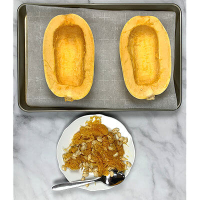 Step 2A - With a spoon, scoop the seeds and the strands that hold the seeds. You end up with a nice clean inside.