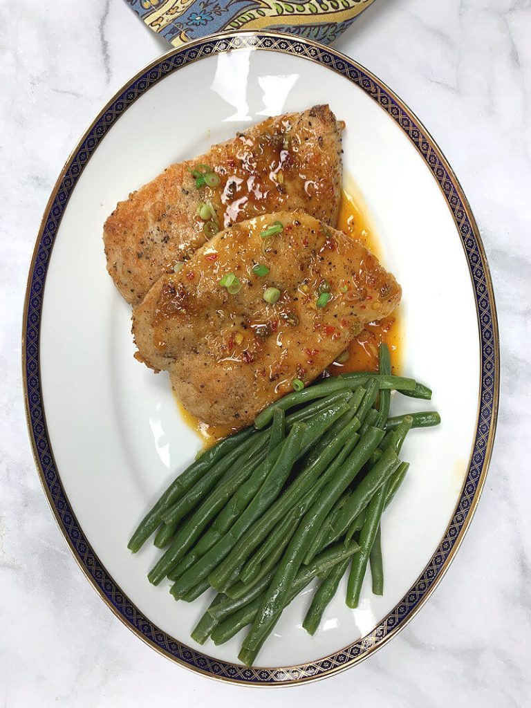 Jalapeno Turkey Cutlets on a oval dish with string beans.