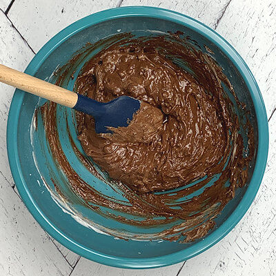 Step 5 - Fold melted chocolate and chopped pine nuts into the whipped egg white until combined.