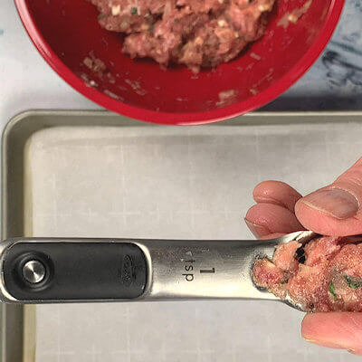 Step 3 - Now form the meatballs. Use a measuring spoon, the size of a teaspoon and start rolling the mini meatballs in with your hands. They will be a little bigger than 1-inch in diameter.
