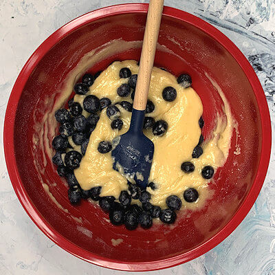 Step 2 - Add wet ingredients to the dry ingredients until incorporated. Fold the blueberries into the batter.