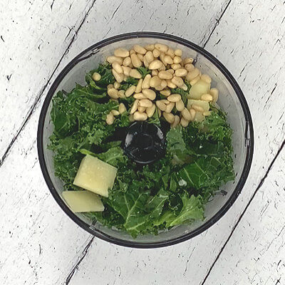 Step 1 - Make the pesto, by adding kale, olive oil, garlic, Pecorino Romano cheese, pine nuts and salt & pepper into a food processor. Process as fine or course as you want it to be.