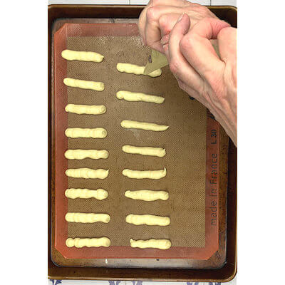 Step 3 - Pipe out strips of cookie dough on baking sheet 