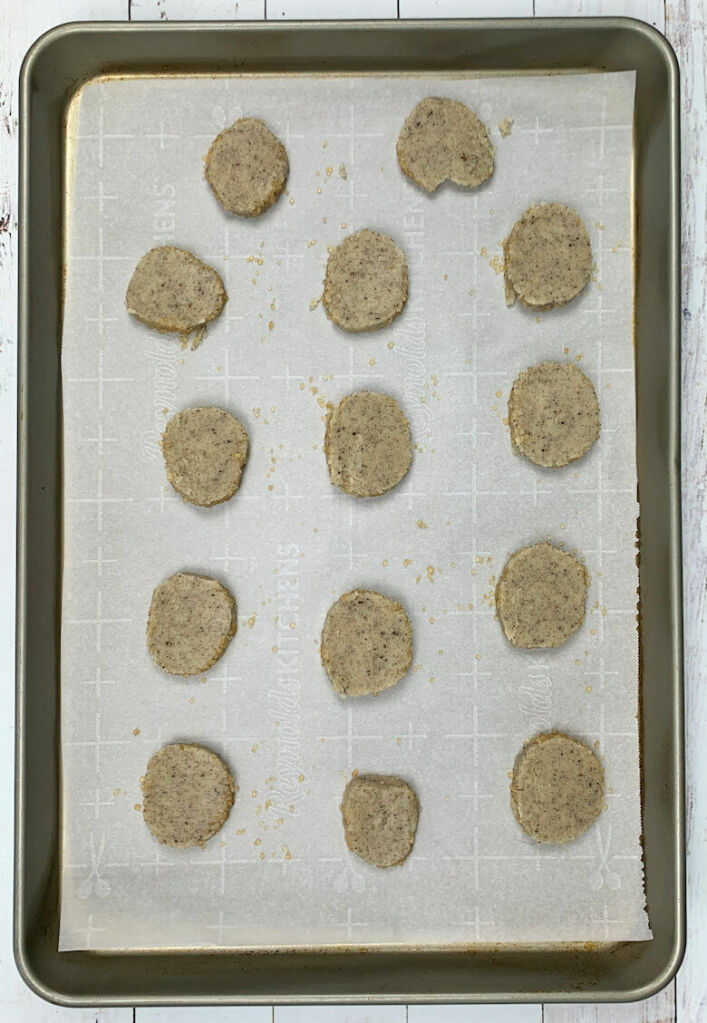Raw earl grey sable cookies on parchment paper lined baking sheet