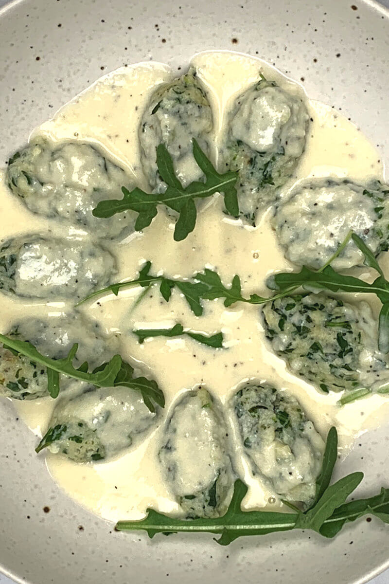 Close up of Arugula Malfatti with Pecorino Sauce