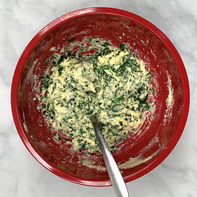 Step 3 - Add grated Parmigiano Reggiano cheese and finely chopped arugula and mix again. Add, salt, pepper and nutmeg to taste.