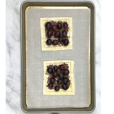 Step 3 - Place the grapes on top of the chocolate and sprinkle each with a pinch of granulated sugar. This is an optional step and depends on the sweetness of the grapes.