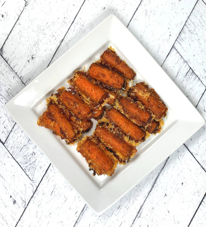 Crispy roasted cheese carrots on a plate.