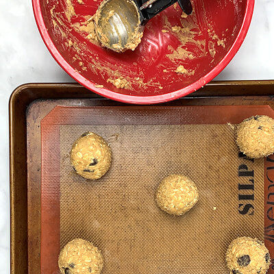 Step 5 - Scoop cookie dough with a large cookie/ice scoop or with tablespoons and place the balls of dough on a lined baking sheet.