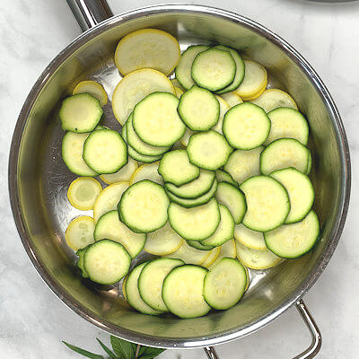 Step 2 - Heat oil in a deep skillet, add slices of squash and zucchini and saute for about 5-7 minutes on medium high heat, until softened.