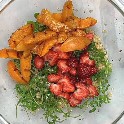 Step 4 - Add arugula, strawberries slices and grilled apricots to couscous mixture.