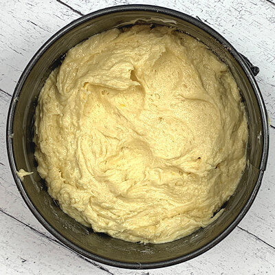 Step 5 - Mix flour and baking powder and add that gradually to the butter/egg mixture. Then pour the batter on top of the almond-sugar-cinnamon bottom and spread out evenly.