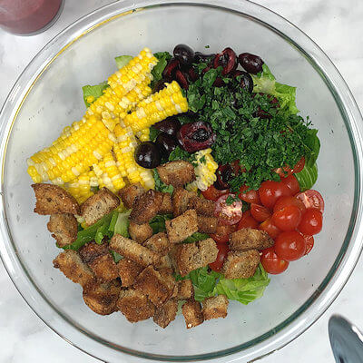 Step 4 - Chop all the ingredients; cherries, tomatoes, lettuce, corn, bread, parsley and basil. Place them in a bowl and mix.