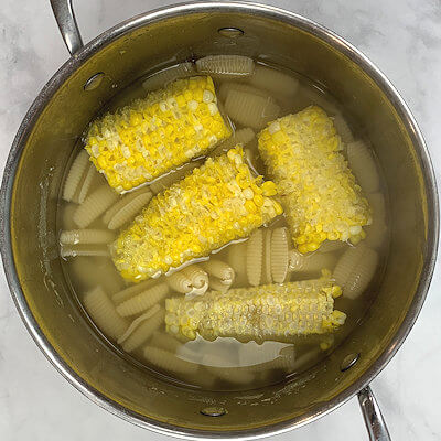 Step 3 - Bring the water, in which you cooked the corn, back to a boil, add the shelled cobs and the pasta and cook the pasta according to the directions on the packaging.