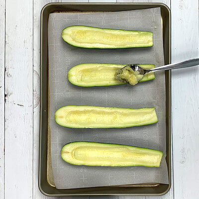 Step 3 - Cut the zucchini in half and scoop out the seed-area with a spoon, don't discard that.